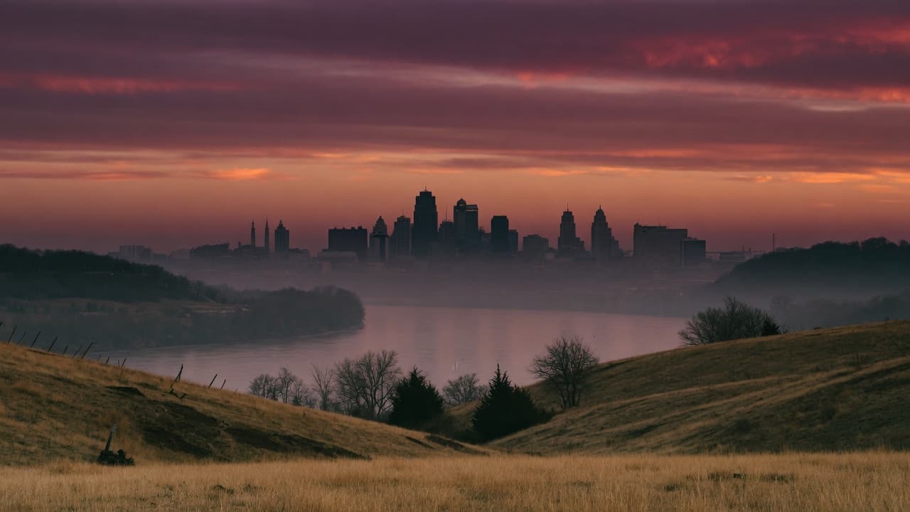 Kansas City skyline at dusk, seen from the Northland across the Missouri River