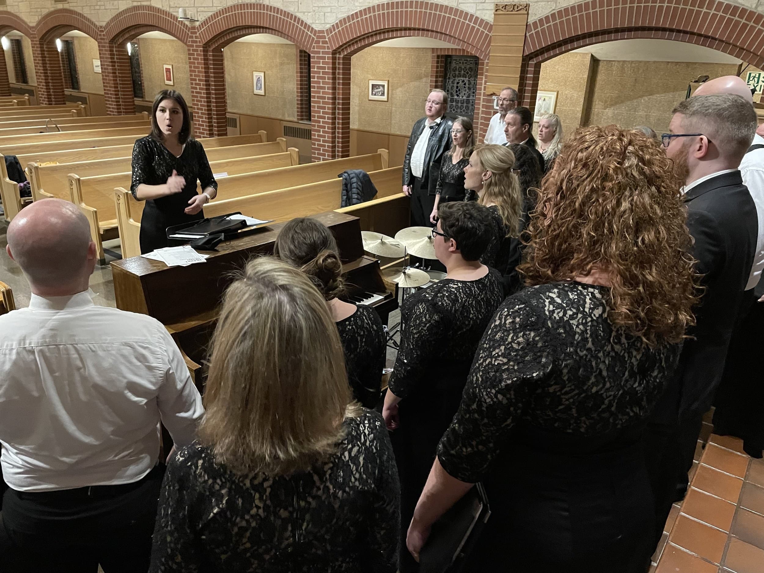 A Choral Intern conducting Festival Singers in concert dress